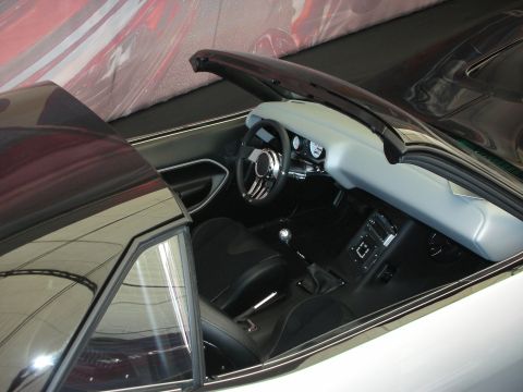1998 Ford Crown Victoria - Top-down view into a custom convertible showing a gray padded dash, billet steering wheel, center console and black bucket seats.