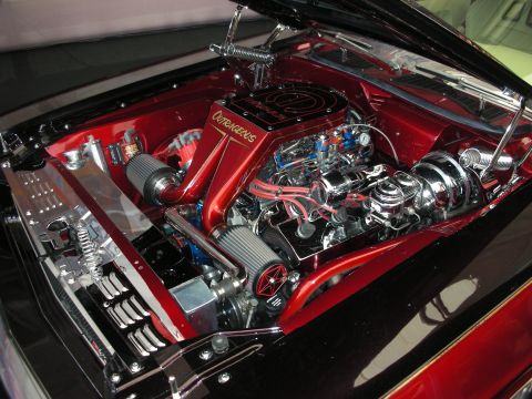 1998 Ford Crown Victoria - Highly detailed custom V8 engine bay with a candy-red firewall, polished chrome accessories and braided lines under a raised hood.