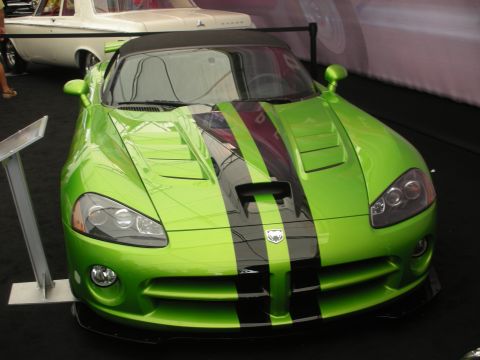 1998 Ford Crown Victoria - Front view of a bright green Dodge Viper coupe with black center stripes and an aggressive splitter, displayed on a black turntable.