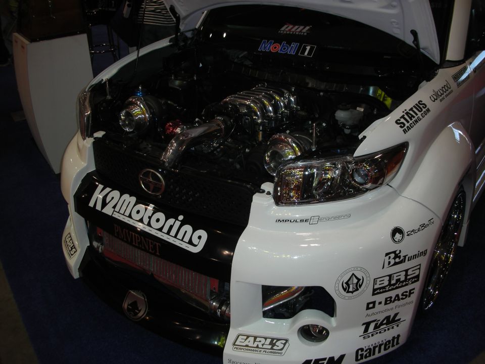 Turbocharged engine bay of a white Scion xB with K2 Motoring graphics