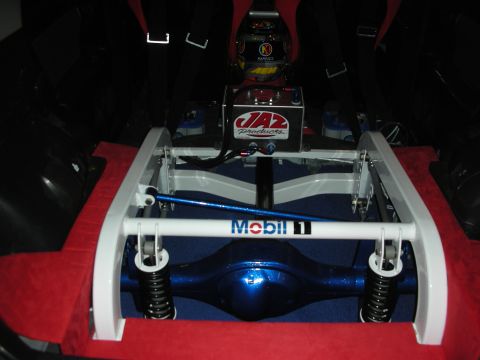 1998 Ford Crown Victoria - Tube-frame rear suspension of a race or show car showing a blue solid axle, coil springs and a Mobil 1 cross-brace.