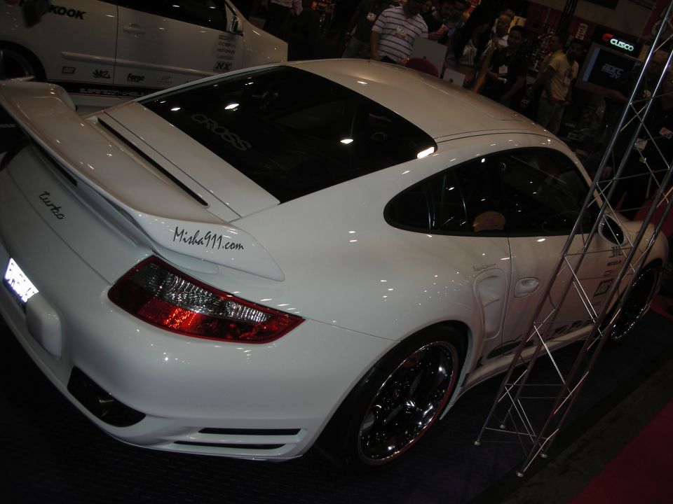 Rear three-quarter of a white Porsche 911 Turbo with whale-tail spoiler