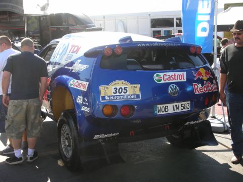 1998 Ford Crown Victoria - Rear view of a blue Volkswagen off-road rally car number 305 with Red Bull, Castrol and BFGoodrich sponsor graphics.