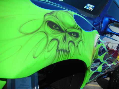 1998 Ford Crown Victoria - Detailed green airbrushed skull with flame work painted on the front fender of a custom show vehicle.