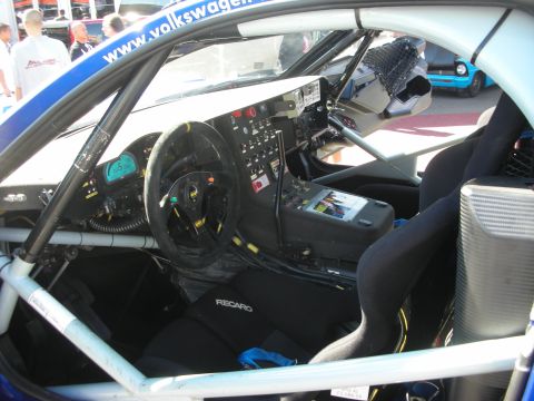 1998 Ford Crown Victoria - Caged interior of a Volkswagen off-road race car showing a Recaro seat, suede steering wheel and a digital dashboard.