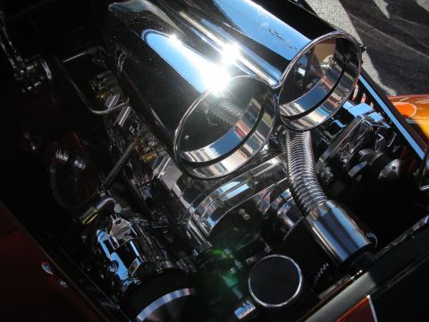 1998 Ford Crown Victoria - Highly polished supercharged engine topped with twin chrome air scoops and braided lines in a custom hot rod engine bay.