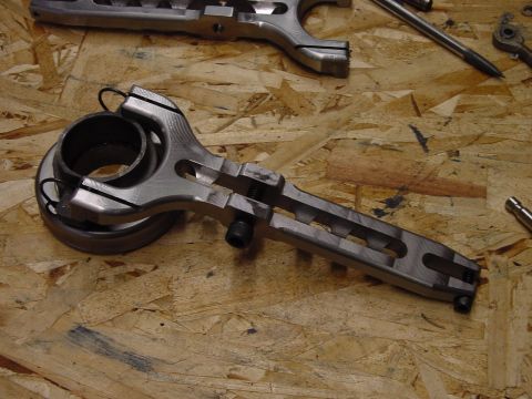 1979 Ford Bronco - Close-up of a clutch fork and bearing assembly, with another part in the background.