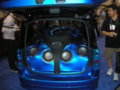 1998 Ford Crown Victoria - open rear hatch of a blue vehicle reveals a custom audio install with four subwoofers and blue accent panels.