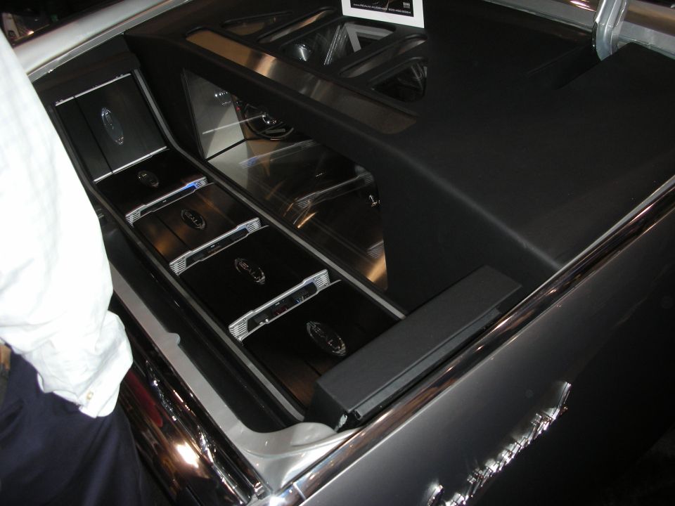 Custom trunk audio install with mirrored panels and chrome amplifiers