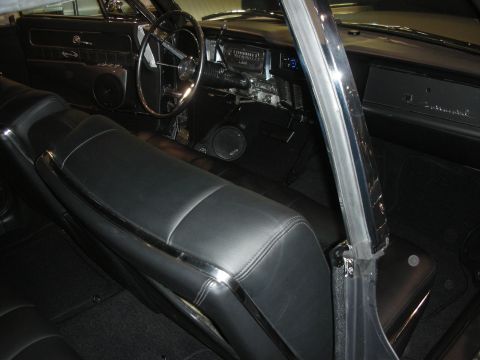 1998 Ford Crown Victoria - black leather interior of a classic Lincoln Continental showing the dash, steering wheel and chrome B-pillar.