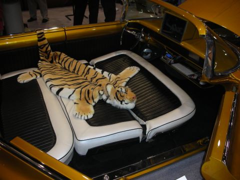 1998 Ford Crown Victoria - tiger-skin rug is draped across the rear bench of a gold custom convertible with white piped upholstery.