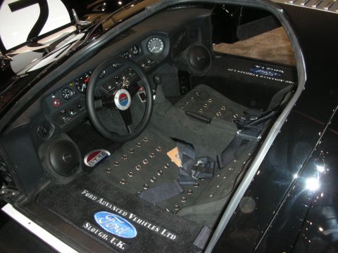 1998 Ford Crown Victoria - black interior of a GT40 race car with a racing dash and Ford Advanced Vehicles Ltd branded floor mats.