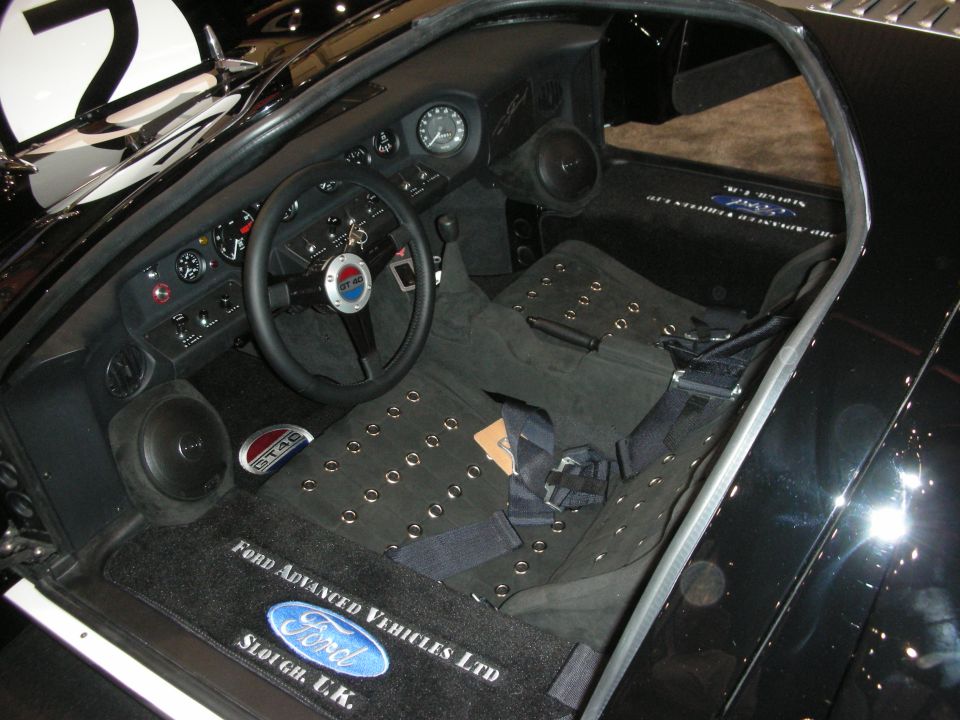 Interior of black GT40 with Ford Advanced Vehicles floor mats, racing dash