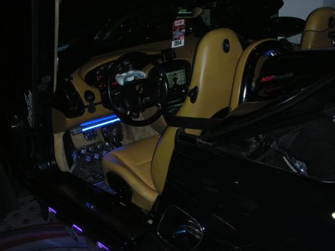 1998 Ford Crown Victoria - Porsche interior in tan and black glows with blue accent lighting across the seats, sills and footwells.