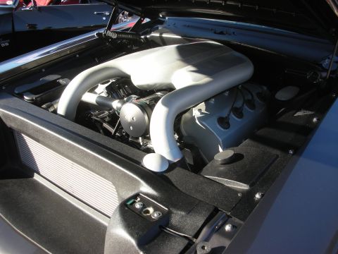 1998 Ford Crown Victoria - custom silver-painted V8 engine bay featuring a smooth fabricated intake plenum and tubular runners in a detailed bay.