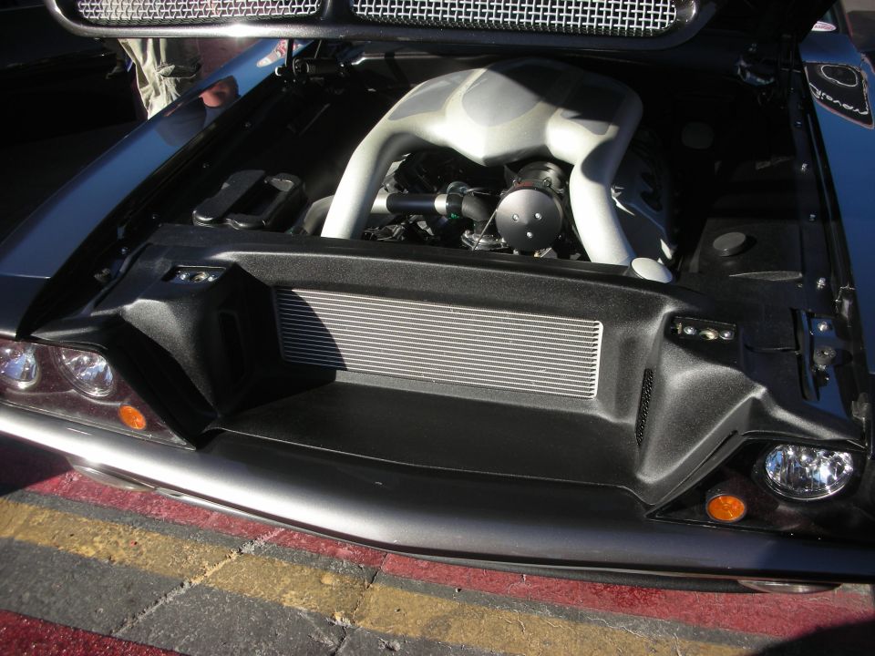 Black sports car engine bay with front-mount intercooler