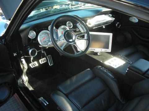 1998 Ford Crown Victoria - custom black leather interior featuring a billet steering wheel, white-faced gauges and a fold-out LCD screen on the dash.