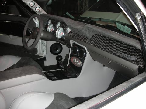 1998 Ford Crown Victoria - Custom car cockpit featuring a carbon-fiber dashboard, gray Alcantara upholstery, white-faced gauges, and a short shifter.