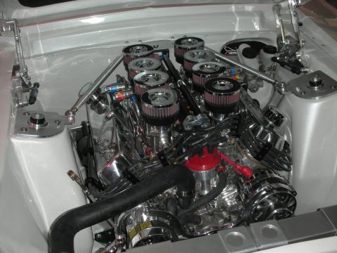 1998 Ford Crown Victoria - Highly polished V8 engine fitted with individual throttle bodies and eight K&N velocity-stack air filters in a white engine bay.
