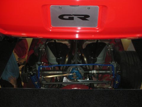 1998 Ford Crown Victoria - Rear underside of a red car displayed on mirrors, showing blue suspension, exhaust, and a GR-branded license plate.