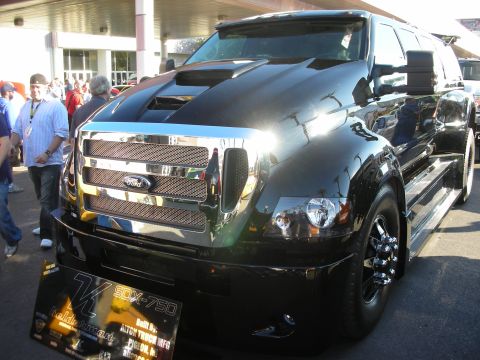 1998 Ford Crown Victoria - Black Ford F-650 medium-duty crew-cab truck with a large chrome mesh grille and cowl hood displayed at a show.