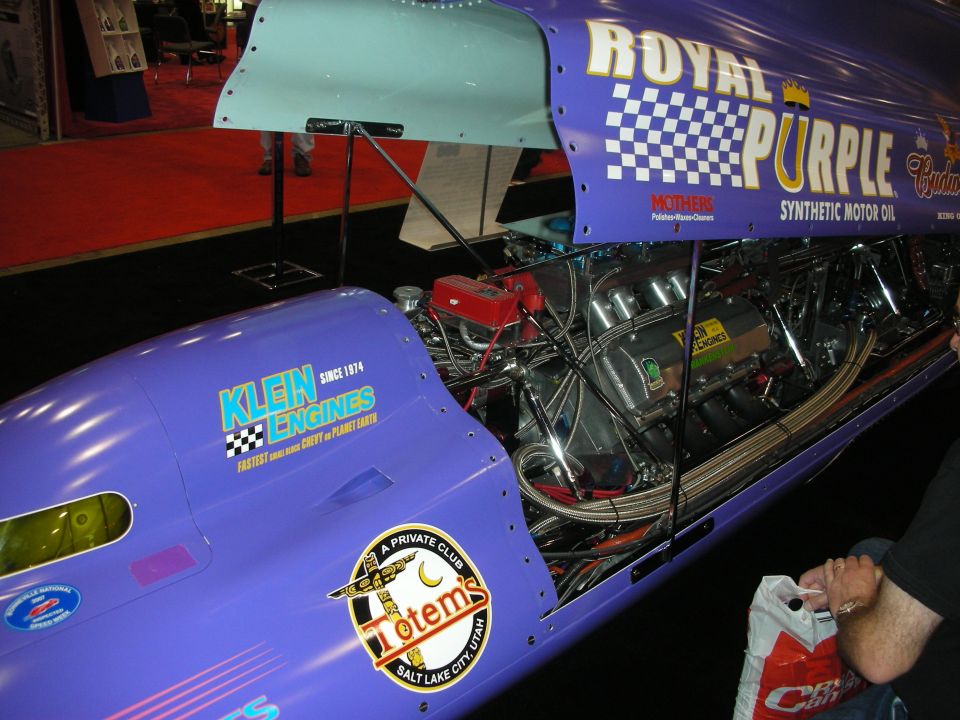 Purple Royal Purple dragster body with exposed engine at indoor show