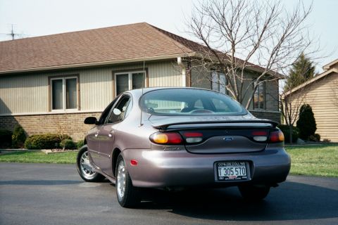 1996 Ford Taurus - The rear of a 1996 Ford Taurus sedan is shown parked on a driveway.
