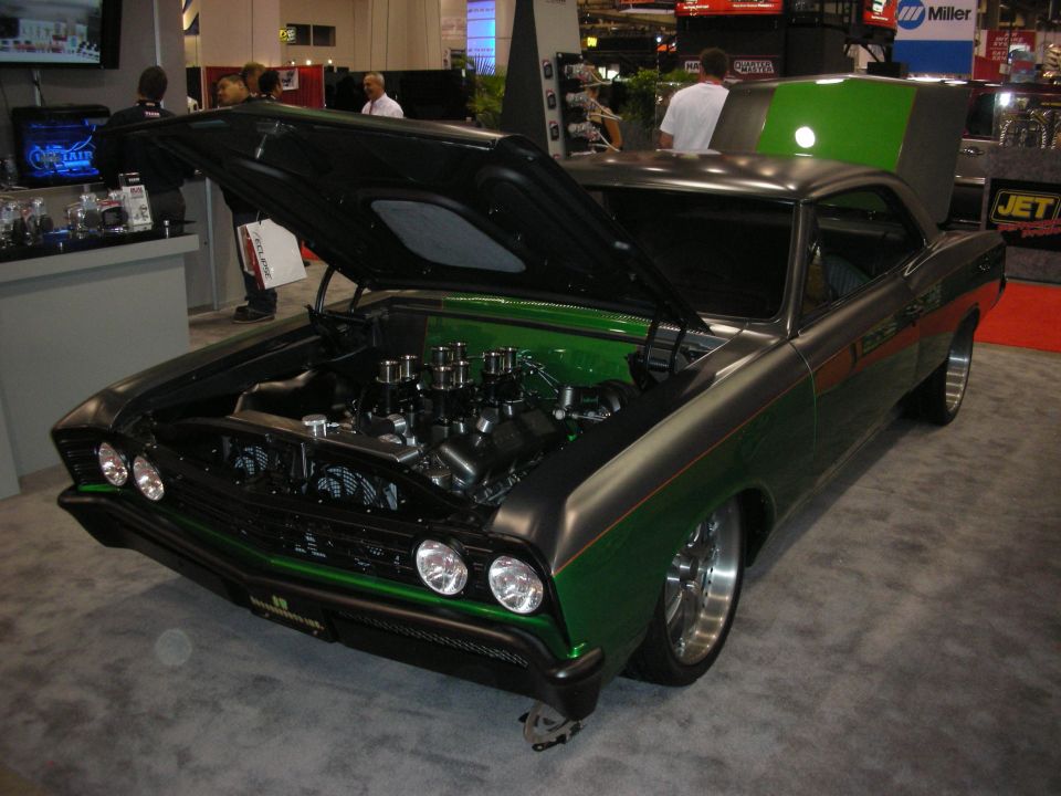 Green and gray custom muscle car front three-quarter with hood open at expo