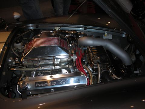 1998 Ford Crown Victoria - Highly polished V8 engine bay with chrome valve covers and a Powered by Roush plate in a custom car.