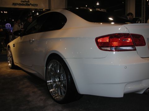 1998 Ford Crown Victoria - Rear three-quarter view of a glossy white two-door coupe lowered on polished deep-dish wheels at an indoor show.