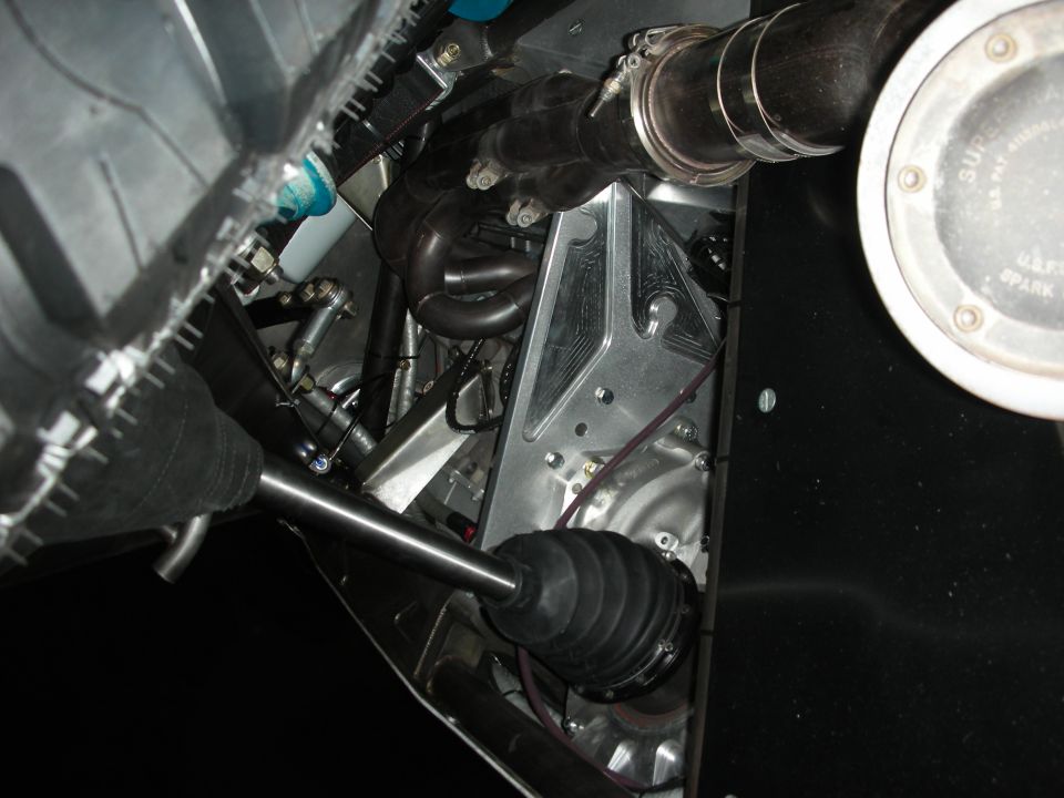 Drivetrain and CV-axle detail beneath an off-road race vehicle