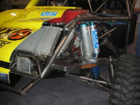 1998 Ford Crown Victoria - Front corner of a yellow tube-chassis off-road race truck with King racing shocks, an intercooler and a mud tire.