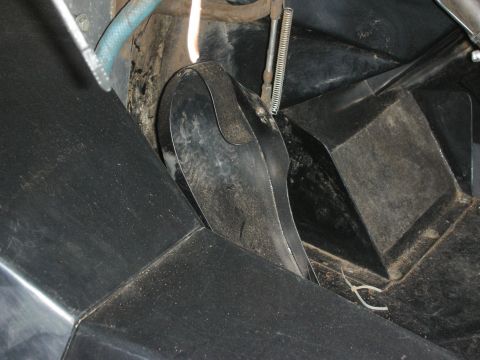 1998 Ford Crown Victoria - Tight shot of a black metal pedal and surrounding floor structure inside a vehicle, with a teal hose visible.