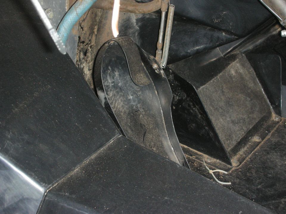 Close-up of a black pedal assembly and floor area inside a vehicle