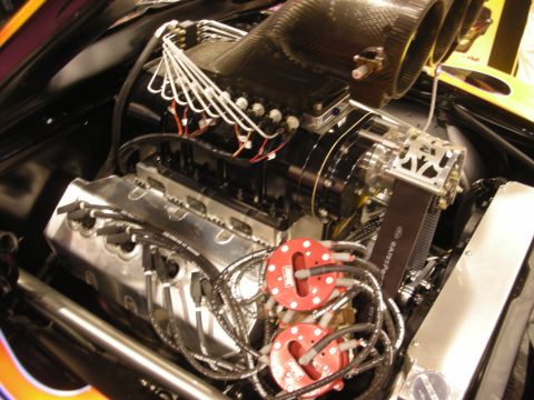 1998 Ford Crown Victoria - Polished V8 engine fitted with a carbon-fiber injector scoop, braided wiring, and red coil packs inside a custom engine bay.
