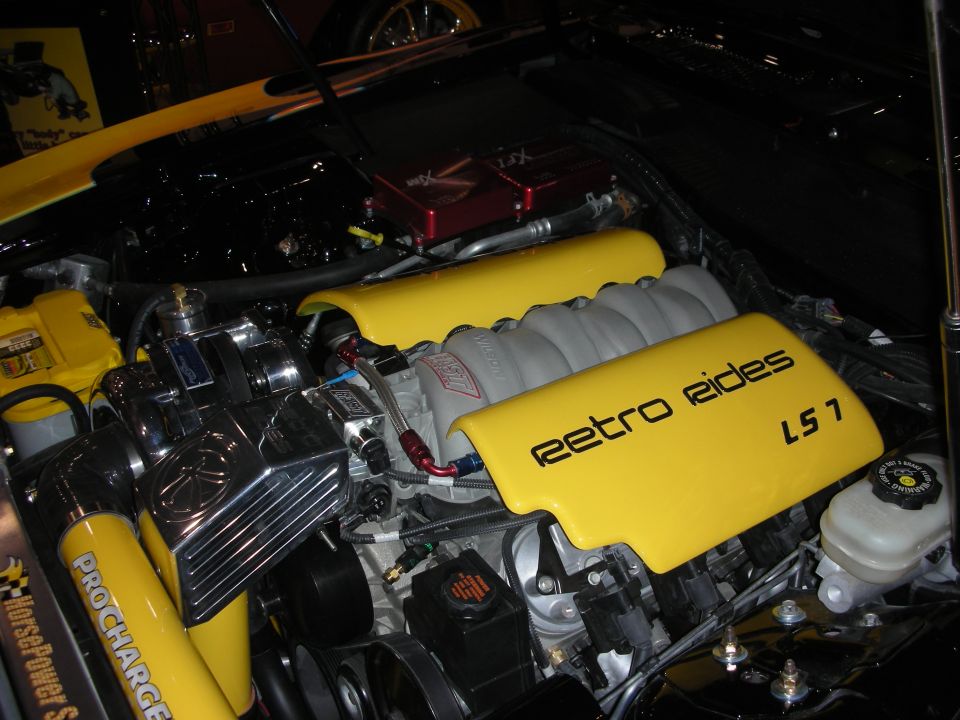 Yellow Retro Rides LS7 engine cover with ProCharger in a bright engine bay