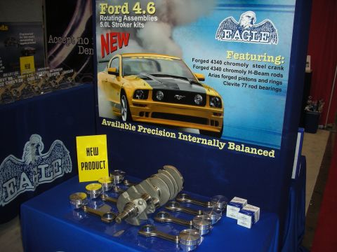 1998 Ford Crown Victoria - Eagle vendor display promoting Ford 4.6 and 5.0L stroker kits, with a crankshaft, pistons, and rods laid out on a blue table.