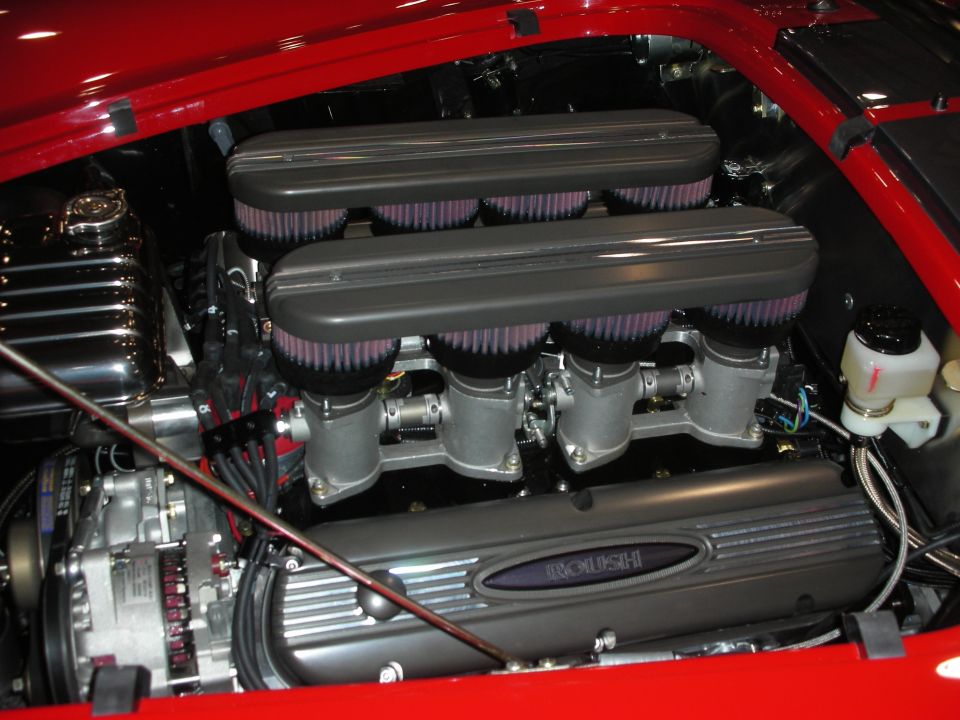 V8 engine with eight individual air filters in a red engine bay, Roush valve cover