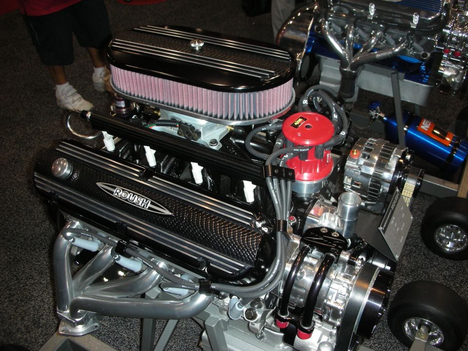 Crate V8 engine with round air filter and Roush valve covers on a stand