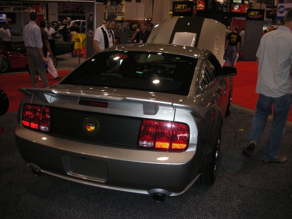 Silver Ford Mustang coupe rear view with spoiler at trade show