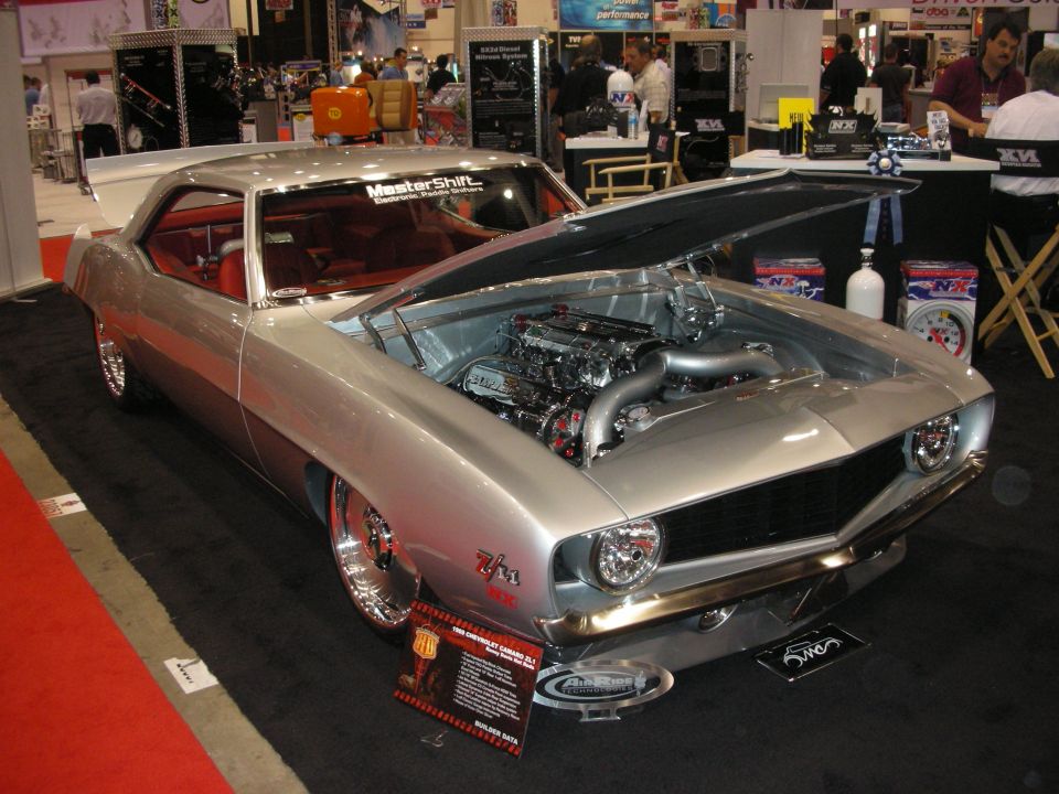 Silver Chevrolet Camaro Z/28 with exposed engine and red interior at show