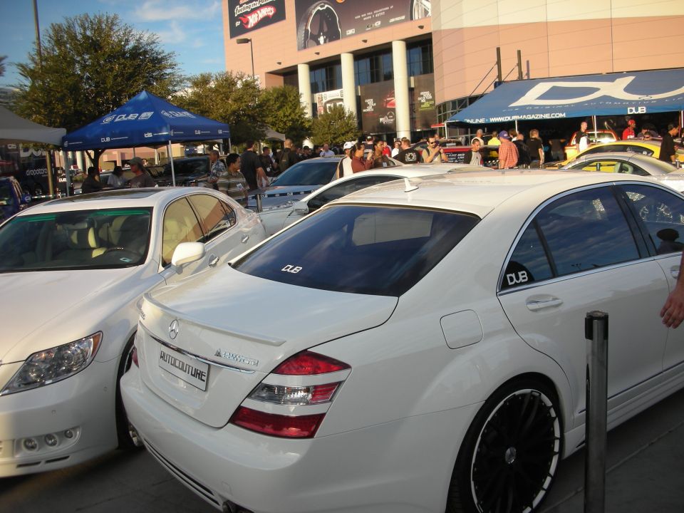 White Mercedes-Benz S-Class sedan with black wheels at an outdoor show