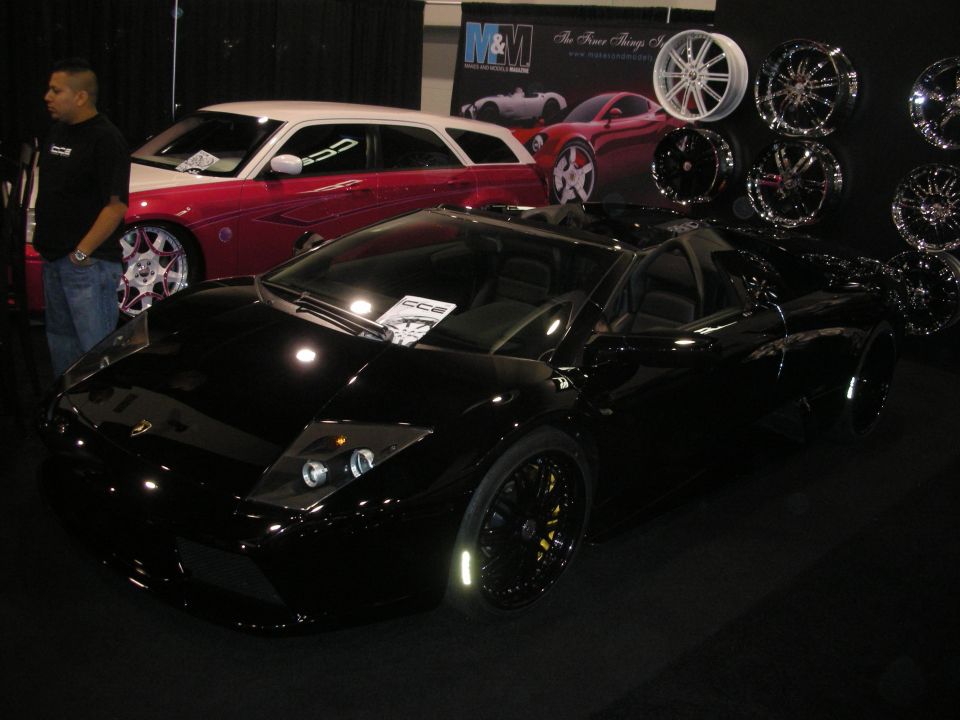 Black Lamborghini Murcielago in front of a wheel display wall