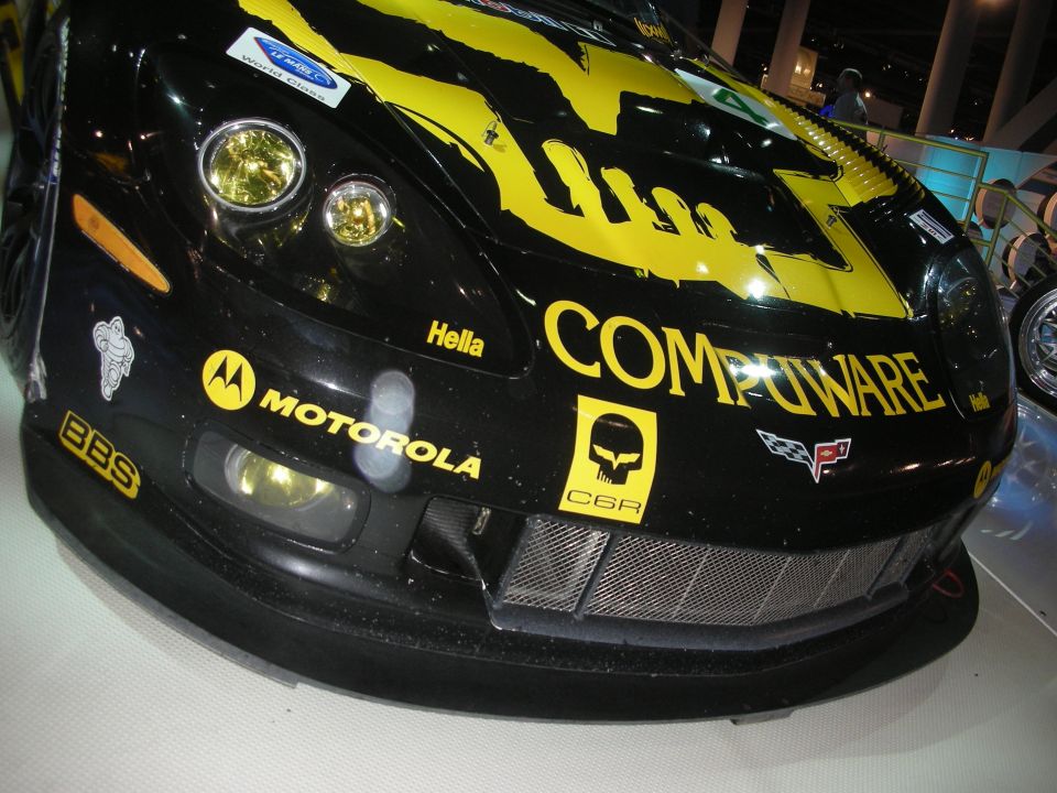 Front corner of a black and yellow Compuware C6.R Corvette race car