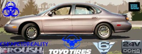 1996 Ford Taurus - Side view of a tan 1996 Ford Taurus sedan.
