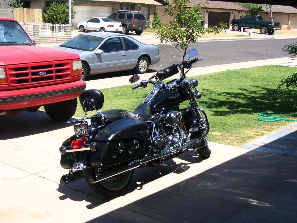 Black Harley-Davidson touring motorcycle parked on a suburban driveway