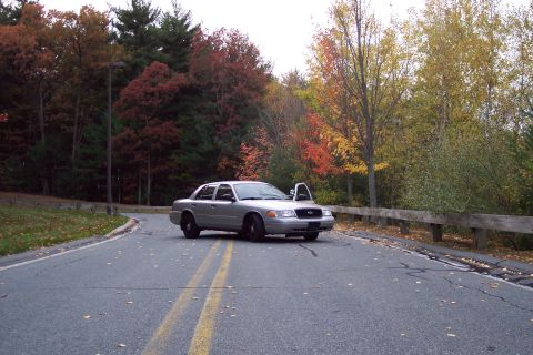 2001 Ford Crown Victoria - Silver 2001 Ford Crown Victoria parked on a road during autumn, with the driver's door ajar.