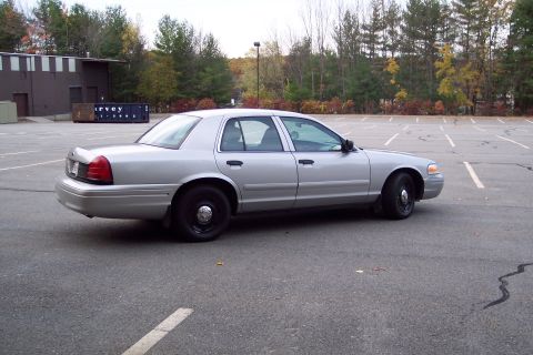 2001 Ford Crown Victoria - This silver 2001 Ford Crown Victoria sedan is seen from the side in a parking lot.
