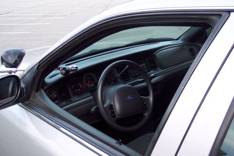 2001 Ford Crown Victoria - The interior of a 2001 Ford Crown Victoria is visible through the open driver's side window.