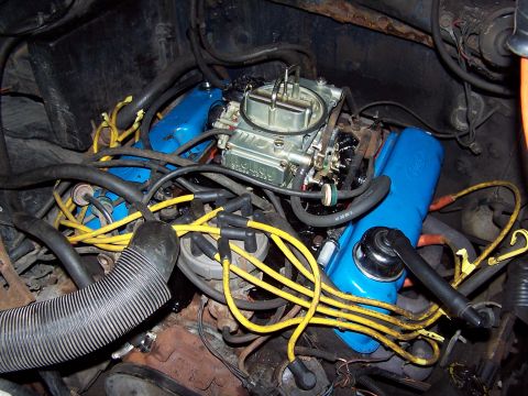 1986 Ford Bronco - Engine bay detail showing carburetor, valve covers, and spark plug wires.